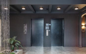 a pair of elevators in a lobby of a building